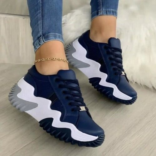 breathable vulcanized platform sneakers for women, shown on foot with jeans, featuring a unique wavy sole and lace-up design.