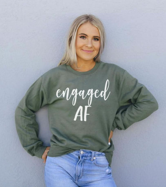 "Model wearing Engaged AF Sweatshirt in military green."